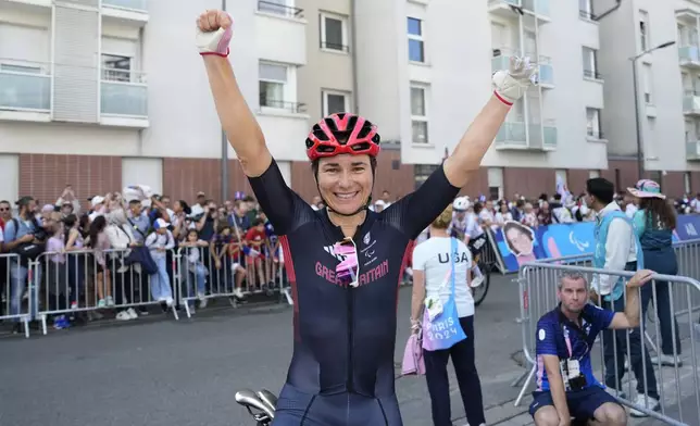 Britain's Sarah Storey celebrates after winning the gold medal in the women's C4-5 road race during the 2024 Paralympics, Friday, Sept. 6, 2024, in Clichy-sous-Bois, France. (AP Photo/Aurelien Morissard)