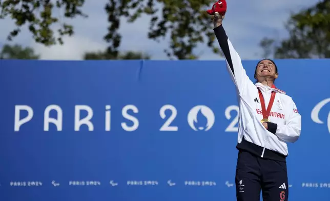 Britain's Sarah Storey celebrates with her gold medal after winning the women's C4-5 road race during the 2024 Paralympics, Friday, Sept. 6, 2024, in Clichy-sous-Bois, France. (AP Photo/Aurelien Morissard)