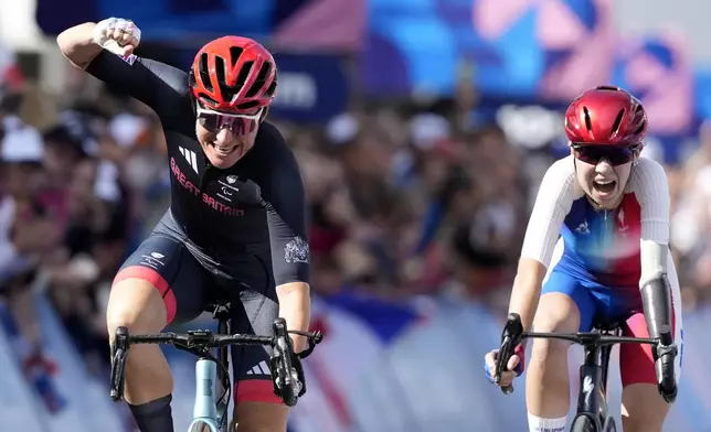 Britain's Sarah Storey, left, finishes first and win the gold medal in the women's C4-5 road race during the 2024 Paralympics, Friday, Sept. 6, 2024, in Clichy-sous-Bois, France. (AP Photo/Aurelien Morissard)