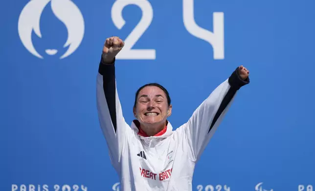 Britain's Sarah Storey celebrates on the podium after winning the women's C4-5 road race during the 2024 Paralympics, Friday, Sept. 6, 2024, in Clichy-sous-Bois, France. (AP Photo/Aurelien Morissard)