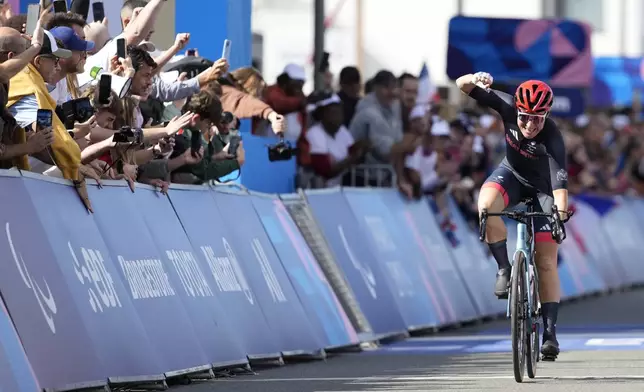 Britain's Sarah Storey celebrates as she wins the gold medal in the women's C4-5 road race during the 2024 Paralympics, Friday, Sept. 6, 2024, in Clichy-sous-Bois, France. (AP Photo/Aurelien Morissard)