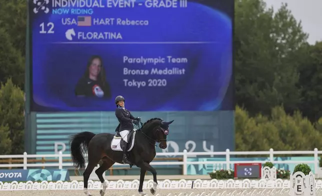 Rebecca Hart of the U.S. competes in the equestrian grade III individual event at the Palace of Versailles, taking home the gold medal at the 2024 Paralympics, Tuesday, Sept. 3, 2024. (AP Photo/Kileigh Kane)