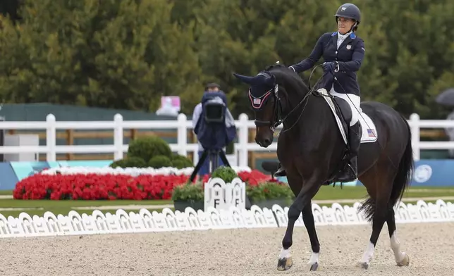 Rebecca Hart of the U.S. competes in the equestrian grade III individual event at the Palace of Versailles, taking home the gold medal at the 2024 Paralympics, Tuesday, Sept. 3, 2024. (AP Photo/Kileigh Kane)