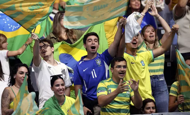 Fans of the Brazil Mens' Goalball team cheer for the team on Friday, August 30, 2024 at the South Paris Arena during the Paralympic Games in Paris. Brazil won the match 13-8. (AP Photo/Nathalee Simoneau)