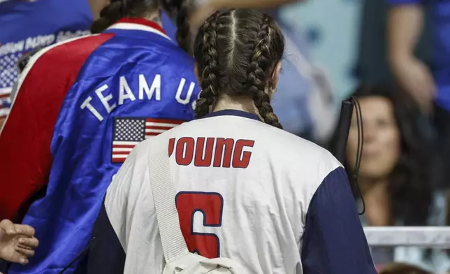 Eliana Mason, fiancé of American goalball team captain Callahan Young, wears a jersey displaying Young's name during the mens' United States versus France goalball game at the Paralympic Games in Paris, Saturday, Aug. 31, 2024. (AP Photo/Felix Scheyer)