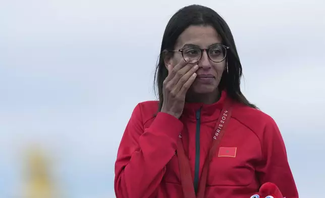 Morocco's Fatima Ezzahra El Idrissi reacts as she stands on the podium with her gold medal after winning the women's marathon T12 at the 2024 Paralympics, Sunday, Sept. 8, 2024, in Paris, France. (AP Photo/Thibault Camus)