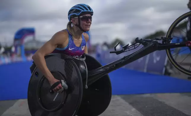 Susannah Scaroni of the U.S. reacts after winning the bronze medal in the women's marathon T54 at the 2024 Paralympics, Sunday, Sept. 8, 2024, in Paris, France. (AP Photo/Thibault Camus)