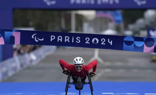 Switzerland's Catherine Debrunner wins the women's marathon T54 at the 2024 Paralympics, Sunday, Sept. 8, 2024, in Paris, France. (AP Photo/Thibault Camus)