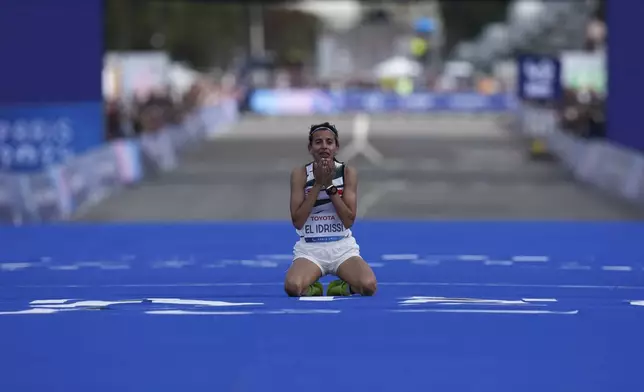 Morocco's Fatima Ezzahra El Idrissi celebrates as she wins the women's marathon T12 at the 2024 Paralympics, Sunday, Sept. 8, 2024, in Paris, France. (AP Photo/Thibault Camus)