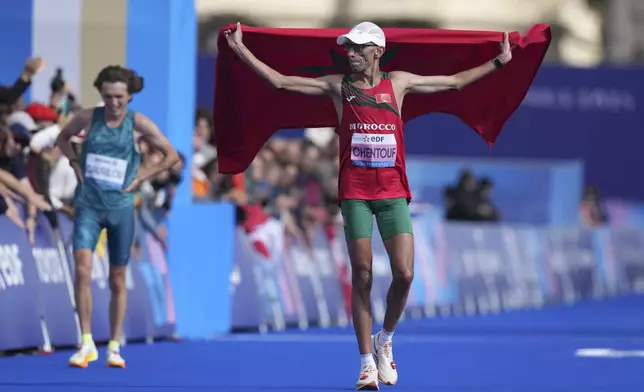 Bronze medalist Morocco's El Amin Chentouf celebrates after the men's marathon T12 at the 2024 Paralympics, Sunday, Sept. 8, 2024, in Paris, France. (AP Photo/Thibault Camus)