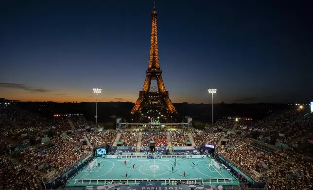 Blind paralympic soccer players from France and China compete in a Preliminary Round Group A - Match 4, at the Eiffel Tower Stadium, during the 2024 Paralympics, Sunday, Sept. 1, 2024, in Paris, France. (AP Photo/Emilio Morenatti)