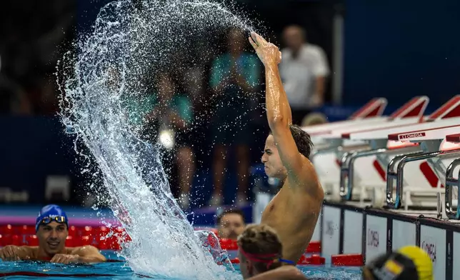 Paralympic athlete Ugo Didier, of France, celebrates by hitting the water after winning the Men's 400 Freestyle -S9, during the 2024 Paralympics, Thursday, Aug. 29, 2024, in Paris, France. (AP Photo/Emilio Morenatti)