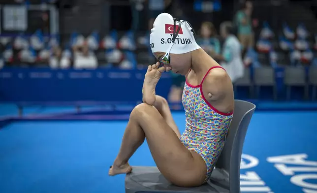 Sevilay Ozturk, of Turkey, adjusts her glasses during a warm up ahead of the competition, during the 2024 Paralympics, Tuesday, Sept. 3, 2024, in Paris, France. (AP Photo/Emilio Morenatti)