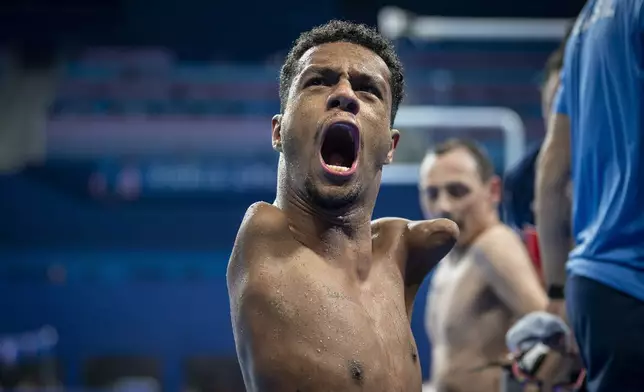 Paralympic athlete Gabriel Araujo, of Brasil, celebrates after winning at men's 200 m Freestyle -S2 final, during the 2024 Paralympics, Monday, Sept. 2, 2024, in Paris, France. (AP Photo/Emilio Morenatti)