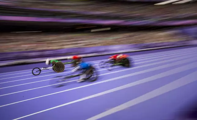 Athletes compite at Men's 100m T54 Round 1 Heat 2/2 at the Stade de France stadium, during the 2024 Paralympics, Wednesday, Sept. 4, 2024, in Paris, France. (AP Photo/Emilio Morenatti)