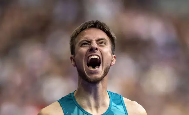 Andrei Vdovin, of NPA, reacts after winning at Men's 400m -T37 final at the Stade de France stadium, during the 2024 Paralympics, Wednesday, Sept. 4, 2024, in Paris, France. (AP Photo/Emilio Morenatti)