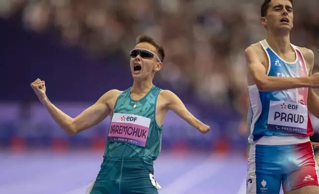 Aleksandr Iaremchuk, of NPA, celebrates after winning at Men's 1500m - T46 final at the Stade de France stadium, during the 2024 Paralympics, Saturday, Aug. 31, 2024, in Paris, France. (AP Photo/Emilio Morenatti)