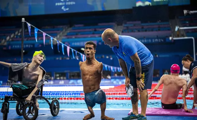 Paralympic athlete Gabriel Araujo, of Brasil, celebrates after winning at men's 200 m Freestyle -S2 final, during the 2024 Paralympics, Monday, Sept. 2, 2024, in Paris, France. (AP Photo/Emilio Morenatti)