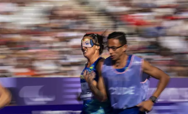 Camila Muller, of Brasil, competes at Women's 1500 -T11 at the Stade de France stadium, during the 2024 Paralympics, Sunday, Sept. 1, 2024, in Paris, France. (AP Photo/Emilio Morenatti)