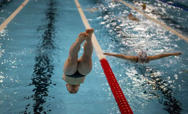 Gus Jinchena, of China, jumps into the pool, during a warm up session ahead of a competition, during the 2024 Paralympics, Tuesday, Sept. 3, 2024, in Paris, France. (AP Photo/Emilio Morenatti)