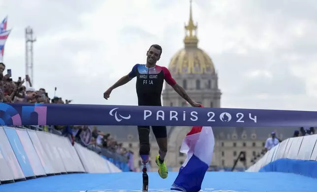 France's Alexis Hanquinquant wins the men's PTS4 Triathlon at the 2024 Paralympics, Monday, Sept. 2, 2024, in Paris, France. (AP Photo/Thibault Camus)