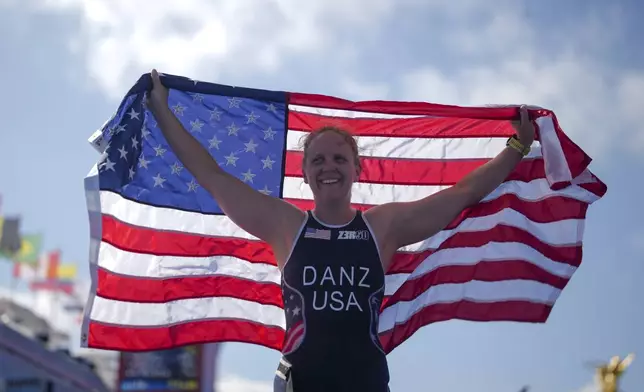 Hailey Danz from the U.S. celebrates after winning the women's PTS2 Triathlon at the 2024 Paralympics, Monday, Sept. 2, 2024, in Paris, France. (AP Photo/Thibault Camus)