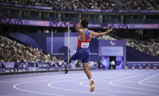 Ezra Frech from the U.S. celebrates after winning the men's 100 m. T63 competition at the 2024 Paralympics, Monday, Sept. 2, 2024, in Paris, France. (AP Photo/Thomas Padilla)