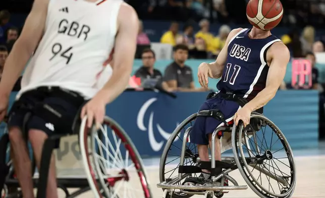 Steve Serio of the U.S. plays the ball during the wheelchair basketball men's gold medal match at the 2024 Paralympics, Saturday, Sept. 7, 2024, in Paris, France. (AP Photo/Thomas Padilla)