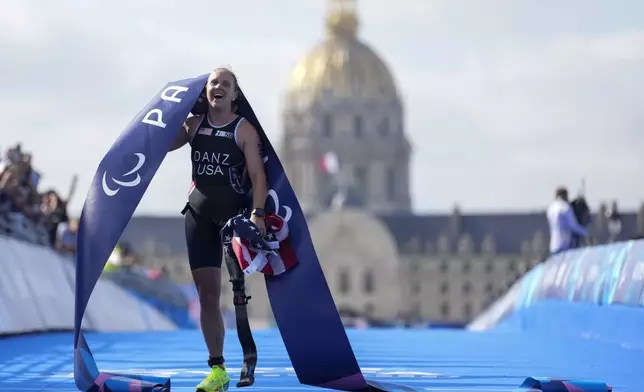 Hailey Danz from the U.S. celebrates after winning the women's PTS2 Triathlon at the 2024 Paralympics, Monday, Sept. 2, 2024, in Paris, France. (AP Photo/Thibault Camus)