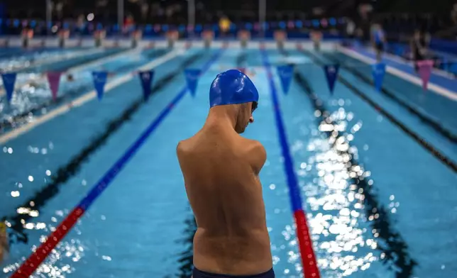 Paralympic athlete Yaroslav Semenenko, of Ukraine, stands next to the pool during a warm up session ahead of the competition, during the 2024 Paralympics, Monday, Sept. 2, 2024, in Paris, France. (AP Photo/Emilio Morenatti)