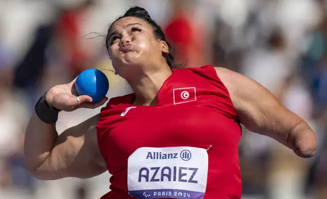 Jihen Azaiez, of Tunisia, competes at Women's Shot Put F46 Final, at the Stade de France stadium, during the 2024 Paralympics, Wednesday, Sept. 4, 2024, in Paris, France. (AP Photo/Emilio Morenatti)