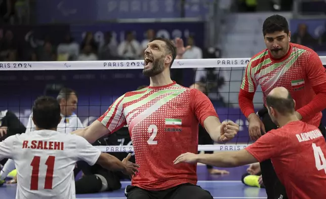 Iran's Morteza Mehrzadselakjani, centre, celebrate with teammates after winning the men's Sitting Volleyball Gold Medal Match between Iran and Bosnia and Herzegovina, at the 2024 Paralympics, Friday, Sept. 6, 2024, in Paris, France. (AP Photo/Leighton Smithwick)