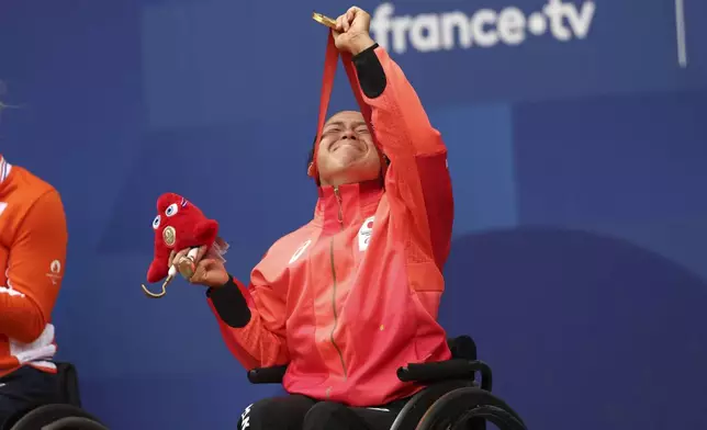 Japan's Yui Kamiji reacts with her gold medal after winning the Women's Singles Wheelchair Tennis at the 2024 Paralympics, on Friday, Sept. 6, 2024 in Paris, France. (AP Photo/Caleb Craig)