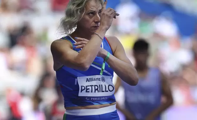 Italy's Valentina Petrillo prepares to compete in the women's 400m T12 round 1, at the Stade de France Stadium, during the 2024 Paralympics, Monday, Sept. 2, 2024, in Paris, France. (AP Photo/Jackson Ranger)