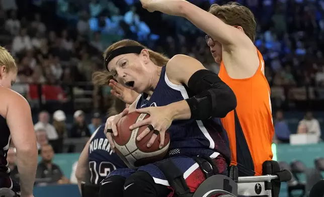 Netherlands' Bo Kramer, right, and Natalie Schneider from the U.S. in action during the gold medal match of the women's wheelchair basketball between Netherlands and United States, at the 2024 Paralympics, Sunday, Sept. 8, 2024, in Paris, France. (AP Photo/Christophe Ena)