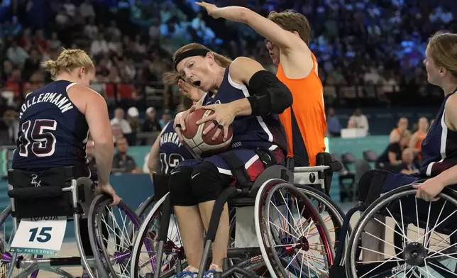 Netherlands' Bo Kramer, right, and Natalie Schneider from the U.S. in action during the gold medal match of the women's wheelchair basketball between Netherlands and United States, at the 2024 Paralympics, Sunday, Sept. 8, 2024, in Paris, France. (AP Photo/Christophe Ena)