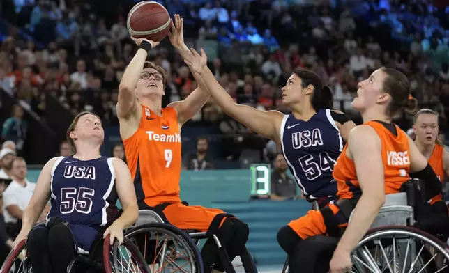 Netherlands' Bo Kramer shoots as Ixhelt Gonzalez from the U.S. defends during the gold medal match of the women's wheelchair basketball between Netherlands and United States, at the 2024 Paralympics, Sunday, Sept. 8, 2024, in Paris, France. (AP Photo/Christophe Ena)