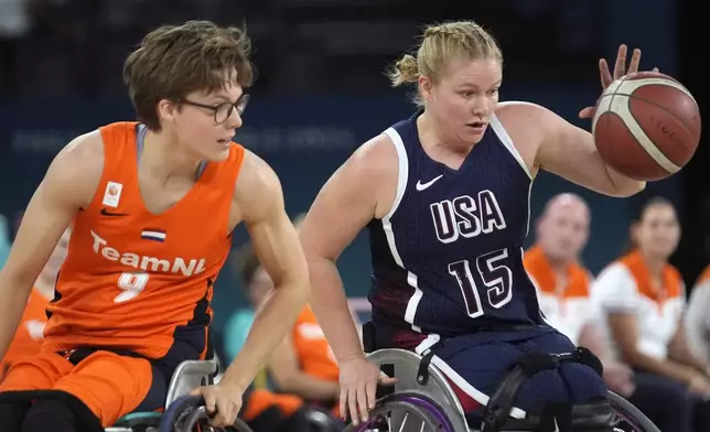 Rose Hollermann of the U.S., right, and Netherlands' Bo Kramer in action during the gold medal match of the women's wheelchair basketball between Netherlands and United States, at the 2024 Paralympics, Sunday, Sept. 8, 2024, in Paris, France. (AP Photo/Christophe Ena)