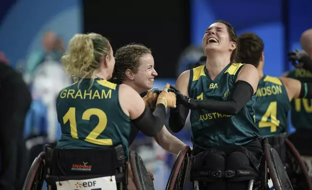 Australia's Ella Sabljak and Australia's Shae Graham, left, celebrate after winning the match during the wheelchair rugby bronze medal match between Australia and Great Britain at the 2024 Paralympics, Monday, Sept. 2, 2024, in Paris, France. (AP Photo/Aurelien Morissard)