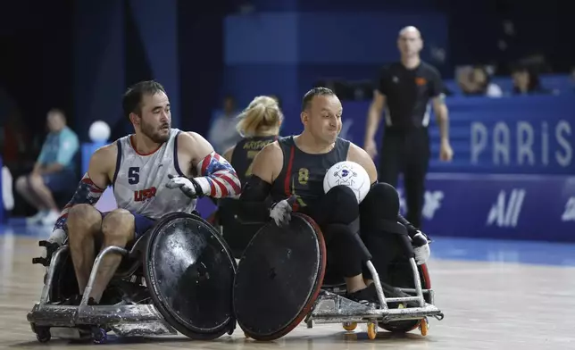 Chuck Aoki from the U.S., left, competes with Germany's Steffen Wecke during their wheelchair rugby match at the Paralympic Games in Paris, Saturday, Aug. 31, 2024. (AP Photo/Mady Mertens)