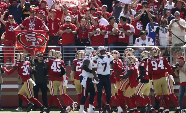 New England Patriots quarterback Jacoby Brissett (7) reacts as San Francisco 49ers players celebrate a touchdown by linebacker Fred Warner on an interception return during the first half of an NFL football game in Santa Clara, Calif., Sunday, Sept. 29, 2024. (AP Photo/Jed Jacobsohn)