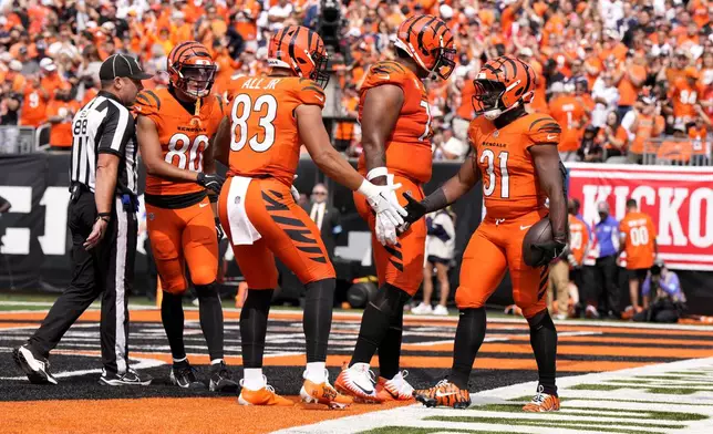 Cincinnati Bengals running back Zack Moss (31) celebrates with teammates after scoring on a 5-yard touchdown run during the second half of an NFL football game against the New England Patriots, Sunday, Sept. 8, 2024, in Cincinnati. (AP Photo/Jeff Dean)