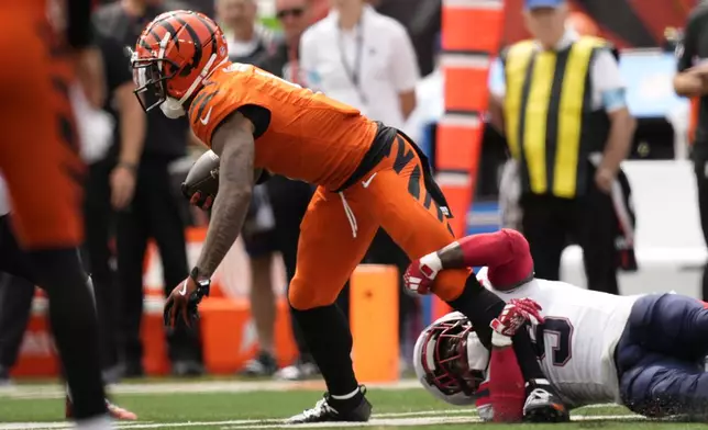 Cincinnati Bengals wide receiver Ja'Marr Chase is tackled by New England Patriots safety Jabrill Peppers (5) during the first half of an NFL football game, Sunday, Sept. 8, 2024, in Cincinnati. (AP Photo/Carolyn Kaster)