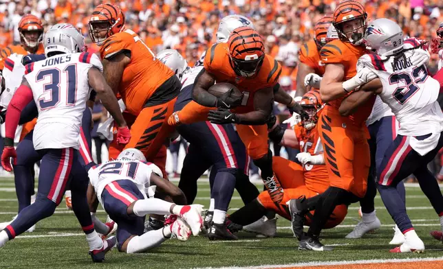 Cincinnati Bengals running back Zack Moss (31) scores on a 5-yard touchdown run during the second half of an NFL football game against the New England Patriots, Sunday, Sept. 8, 2024, in Cincinnati. (AP Photo/Jeff Dean)