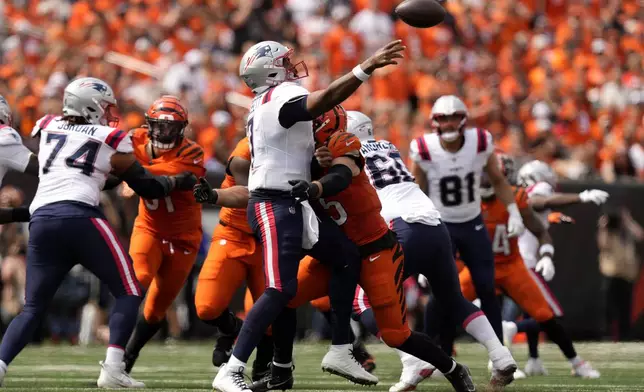 New England Patriots quarterback Jacoby Brissett (7) is hit by Cincinnati Bengals linebacker Logan Wilson (55) as he throws a pass during the second half of an NFL football game, Sunday, Sept. 8, 2024, in Cincinnati. (AP Photo/Carolyn Kaster)