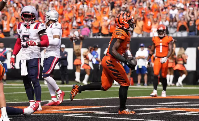 Cincinnati Bengals running back Zack Moss (31) celebrates after scoring on a 5-yard touchdown run during the second half of an NFL football game against the New England Patriots, Sunday, Sept. 8, 2024, in Cincinnati. (AP Photo/Jeff Dean)