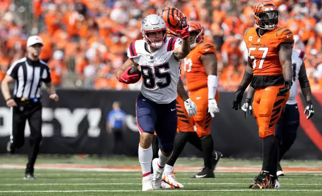 New England Patriots tight end Hunter Henry (85) celebrates in front of Cincinnati Bengals linebacker Germaine Pratt (57) after catching a pass for a first down during the second half of an NFL football game, Sunday, Sept. 8, 2024, in Cincinnati. (AP Photo/Jeff Dean)