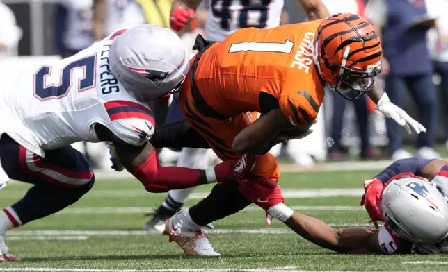 Cincinnati Bengals wide receiver Ja'Marr Chase (1) is tackled by New England Patriots safety Jabrill Peppers (5) after catching a pass during the second half of an NFL football game, Sunday, Sept. 8, 2024, in Cincinnati. (AP Photo/Jeff Dean)