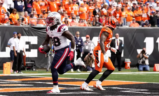 New England Patriots running back Rhamondre Stevenson (38) scores on a 3-yard touchdown run during the first half of an NFL football game against the Cincinnati Bengals, Sunday, Sept. 8, 2024, in Cincinnati. (AP Photo/Jeff Dean)