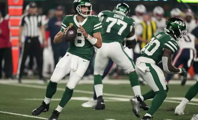 New York Jets quarterback Aaron Rodgers (8) steps back to pass against the New England Patriots during the first quarter of an NFL football game, Thursday, Sept. 19, 2024, in East Rutherford, N.J. (AP Photo/Seth Wenig)